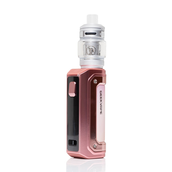 A Geekvape device in a metallic rose gold finish, paired with a clear glass tank and white top cap, shown on a clean white background with a subtle reflection.