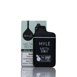 Mylé Meta Box disposable vape device in matte black standing in front of its light green and white packaging box on a reflective white surface.